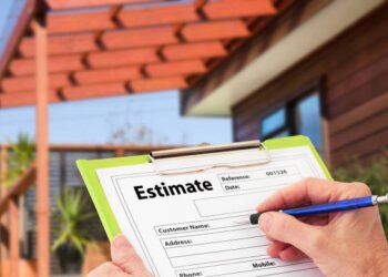 Hand writing an estimate on a clipboard for Home Building Renovation