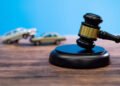 Gavel and model car on the table.
